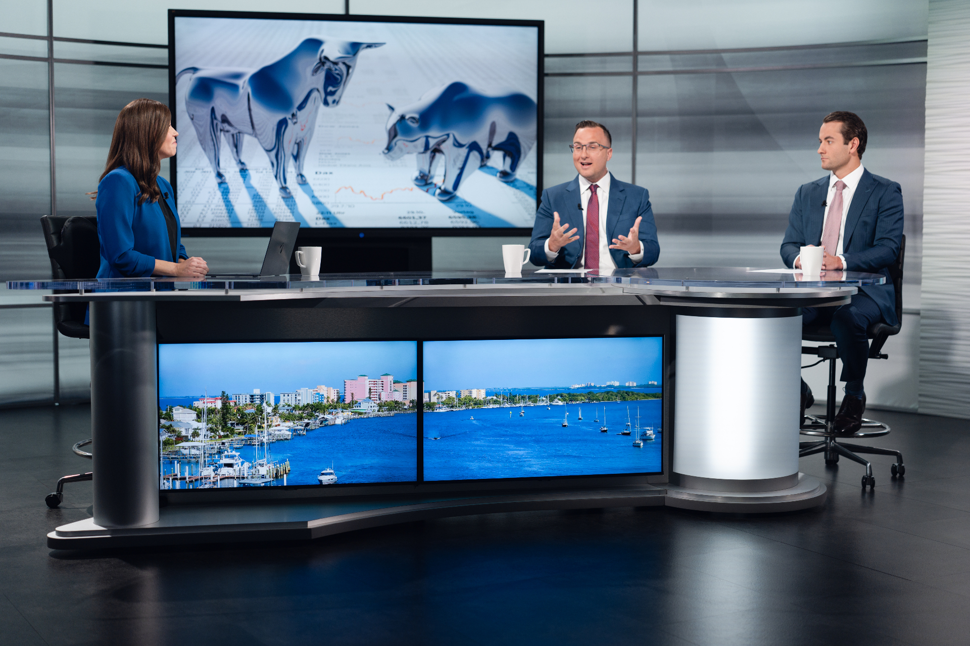 Jerry Sylvester and Dane Spencer on set for a financial media interview, with Fort Myers imagery on the studio desk.